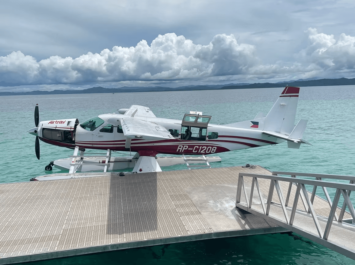 A seaplane docked at Banwa Private Island's jetty, one of the ways guests reach the island